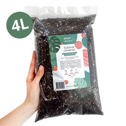 Un sac de terreau universel sombre parsemé de perlite blanche, avec une étiquette verte et rose